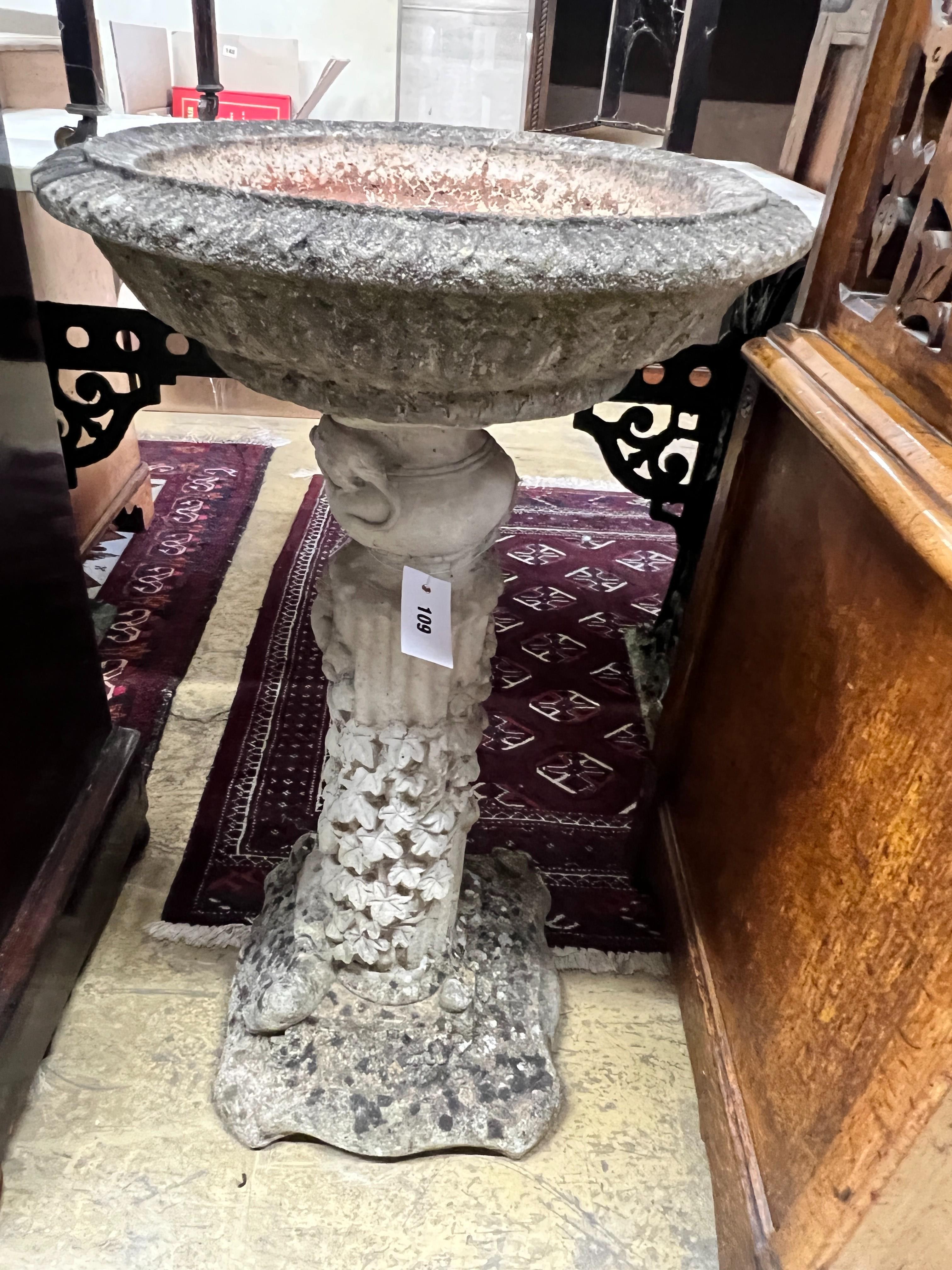 A circular reconstituted stone garden bird bath, diameter 40cm, height 74cm